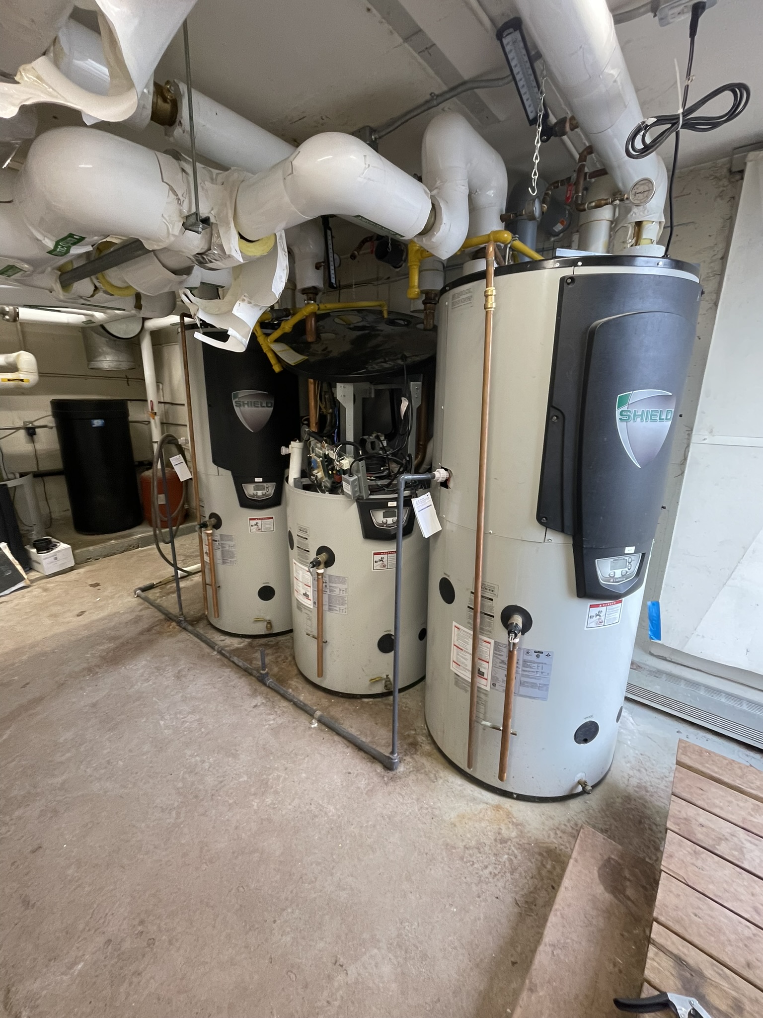 Three-tank commercial boiler installation with overhead gas piping