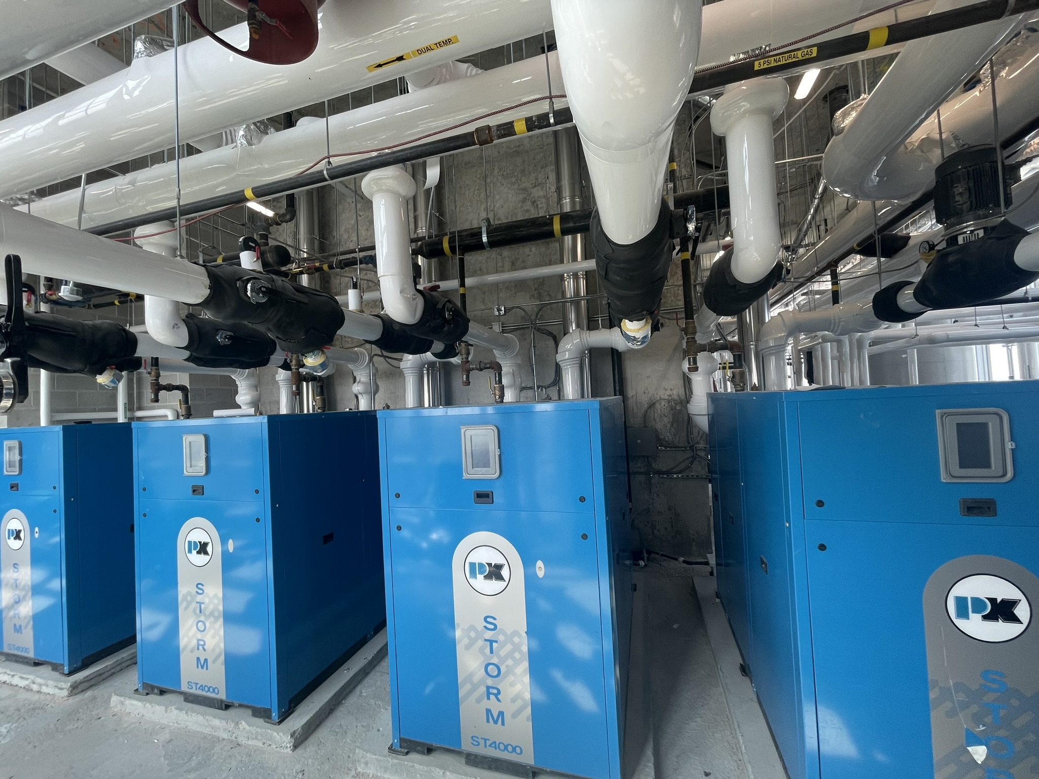 Commercial boiler bank with overhead gas piping